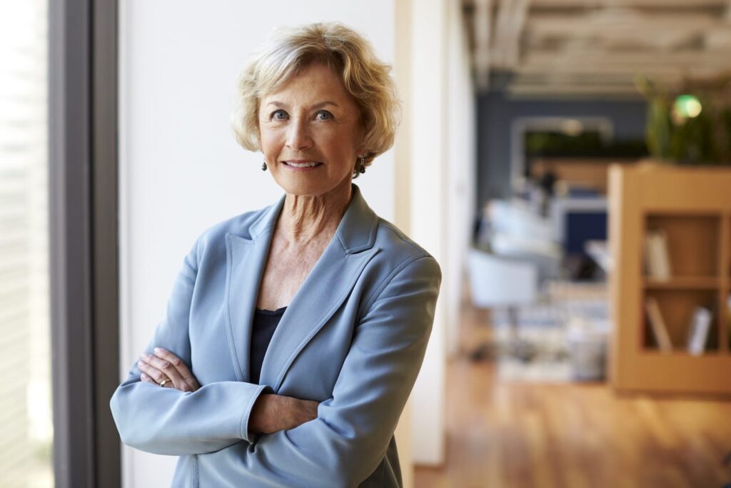 Portrait Of Smiling Senior Businesswoman In KEHVBZY 1024x683