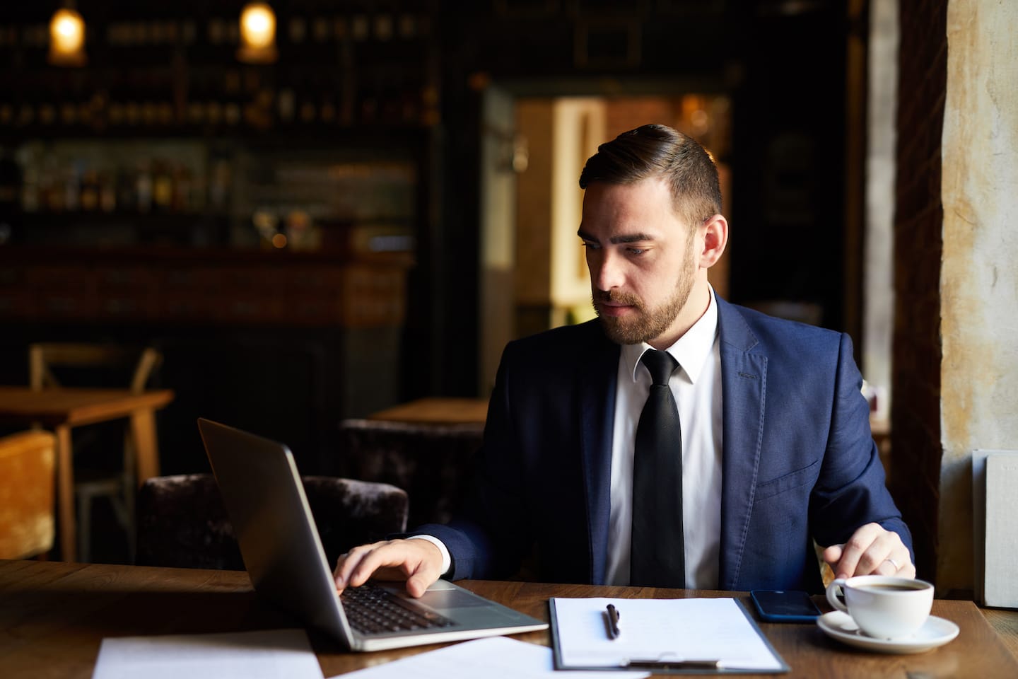 Busy Man Using Laptop In Cafe PX5GAKJ