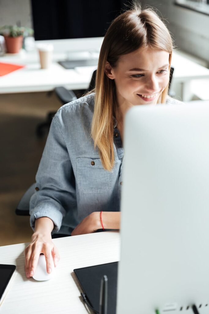 Happy Young Woman Work In Office Using Computer PERMEN2 683x1024